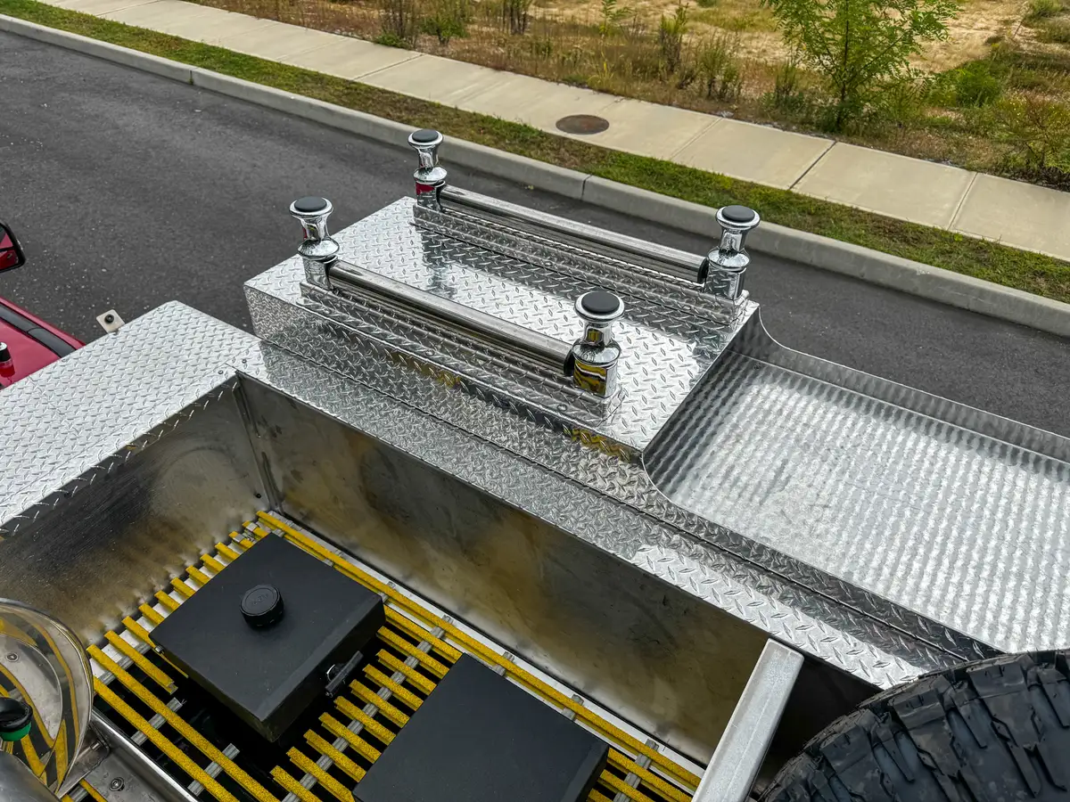 Top deck rear view with spare tire and grating panels.